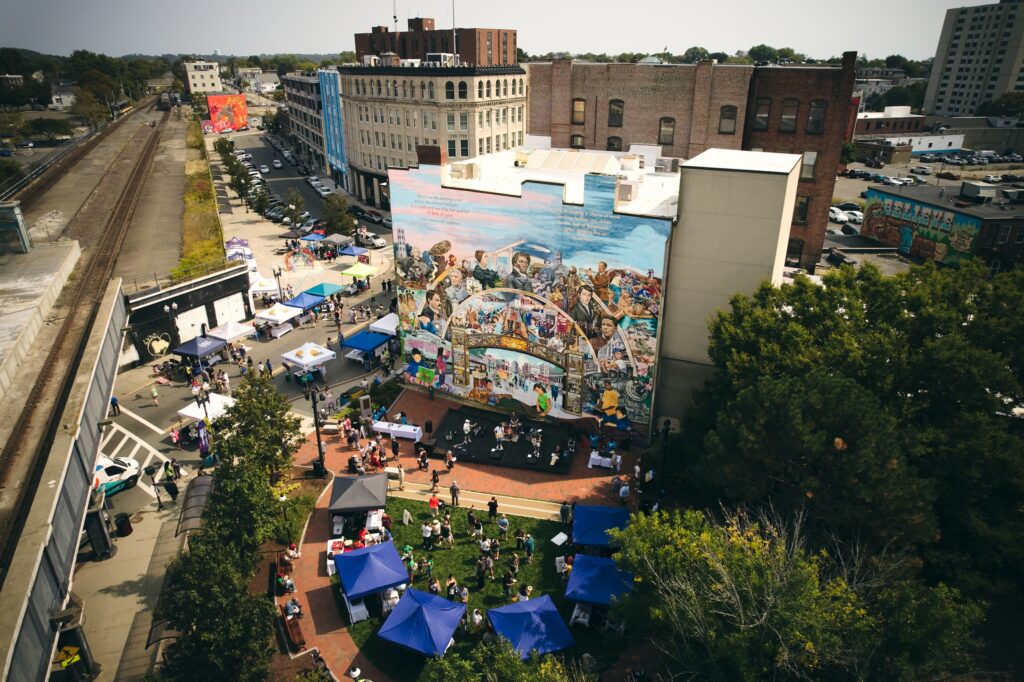 Aerial shot of an urban city park with people gathering in a courtyard