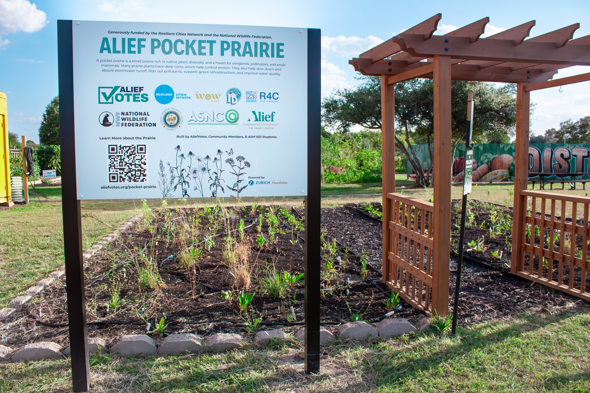 Sign in front of an urban garden